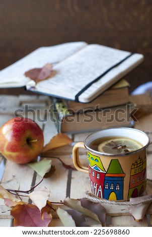 Autumn books and tea with lemon and apple