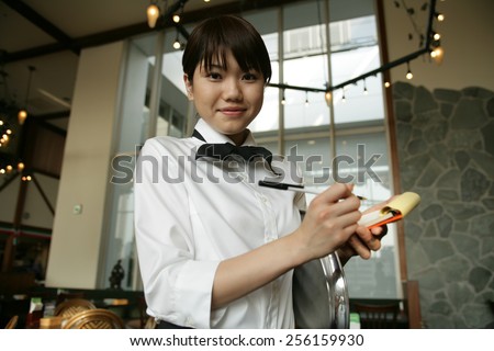 Portrait of a waitress taking an order in a restaurant
