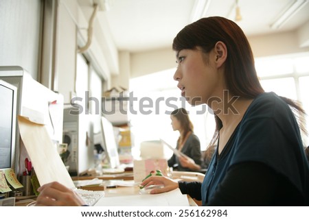 Side profile of a businesswoman working on a computer