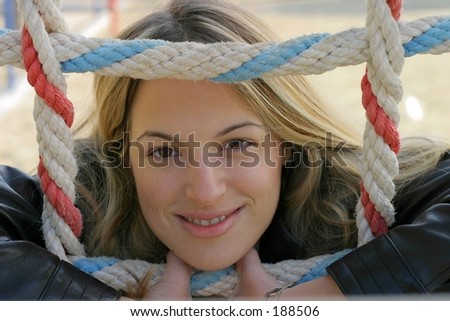 Girl is smiling behind a colored rope