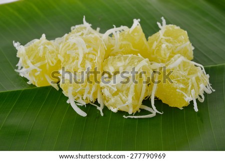 Thai dessert steam-minced cassava with shredded coconut on banana leaf