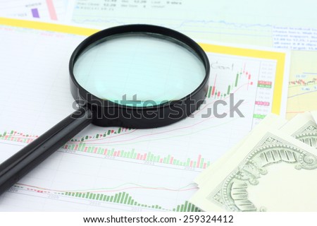 Graphs, magnifier and pen. Analysis charts and graphs of sales.