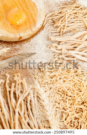 Fresh homemade  four types egg pasta in coiled ribbons made from durum wheat dough for use in traditional Mediterranean cooking. Handmade ribbon pasta. Step on step. See series. Rustic style