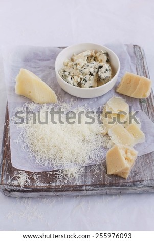 Still life for three types cheese on a rustic green table. Authentic and natural food. Rustic style