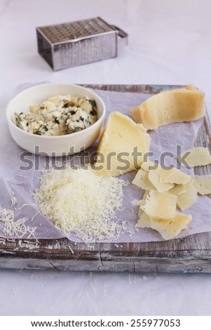 Still life for three types cheese on a rustic green table. Natural and vegetarian food concept. Rustic style.