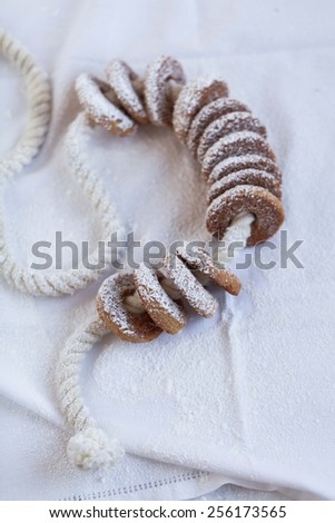 Partial Blurred food background. Homemade cookies with sugar powder arranged on white rustic linen background. Rustic style