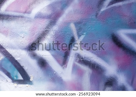 Colorful graffiti wall with spray a paint. Blue background.