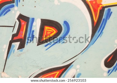 Colorful graffiti wall with spray a paint. Blue and orange background. Urban art.