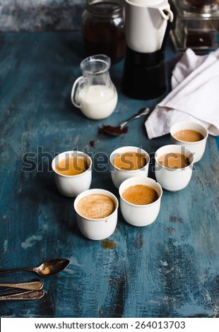 Coffee with milk on a blue metal vintage table.  Rustic style. Low key