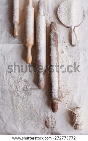 Baking rustic concept. Rolling pins with vintage kitchen board on a flouring surface.