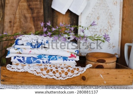 Rustic image with vintage linen embroidery and summer flower.