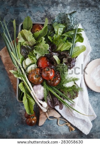Fresh detox vegetables over on blue dark table. Garden, local healthy produce. Rustic style, Top view.