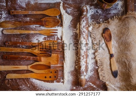 Creative country food concept. Retro image with vintage kitchen wooden utensils and sack cloth from above. Rustic style.
