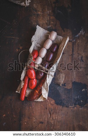 Typical Spanish raw assortment sausage served in rustic paper for preparing bbq food. Natural country food concept.