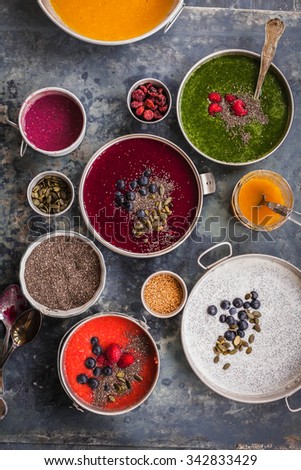 Smoothie bowls food collage smoothie chia bowl breakfast, acai yogurt bowl with super foods seeds on the side. overhead on grey stone surface with natural light .