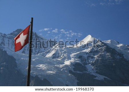 SWISS MOUNTAINS with Swiss Flag in Foreground