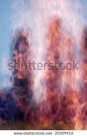 Burning field with warm air and tree
