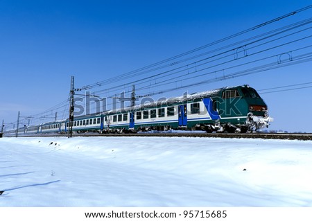 a train passes on a cold winter landscape