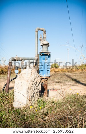 pipe connections in the countryside. Blue Cap