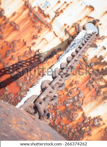 Rusty brown chain. Close up of a rust brown chain of a abandoned boat.