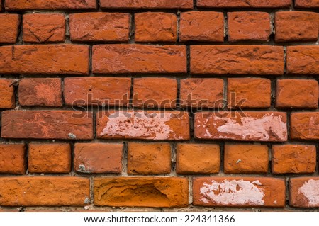 old red bricks wall with big gaps between each brick