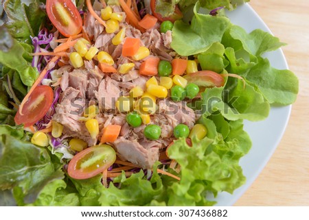 salad tuna with maize corn and pea carrot vegetable on white dish