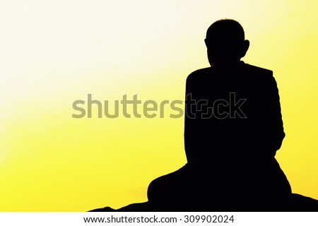 meditation of Thai monk statue with the sunrise