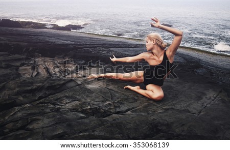 Beautiful girl doing exercises on the coast