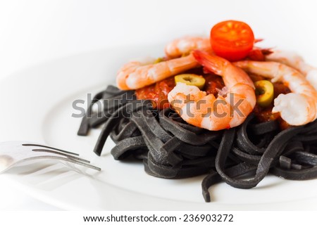 Pasta made with cuttlefish ink with tomato sauce and shrimp on white background