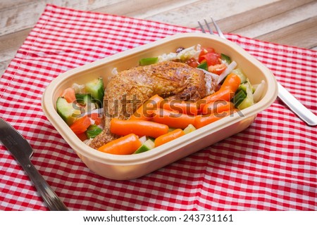 Delivery service grilled chicken with vegetables in plastic box