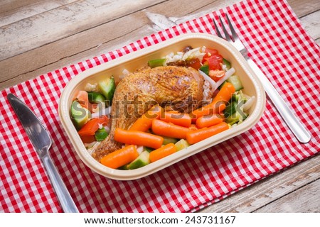 Delivery service grilled chicken with vegetables in plastic box