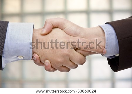 business hand shake in background