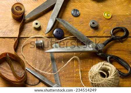 Vintage Background with sewing tools and Sewing kit. Scissors on the old wooden background