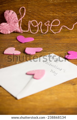 Love letter with pink hearts and a text love in the background
