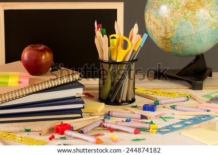 all kind of school accessories on a wooden desk
