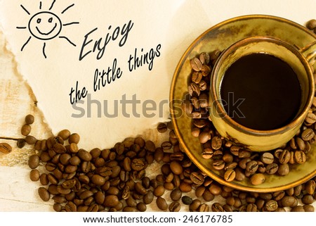 cup of black coffee , greeting card with the text enjoy the little things