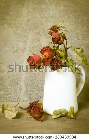 Still life photography : Withered roses on wooden background