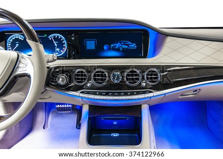 Car dashboard luxury. Beige leather, climate control, speedometer, display, wood decoration & blue ambient light