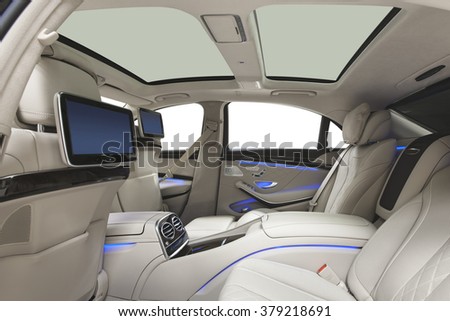 Car interior luxury. Interior of prestige modern car. Leather comfortable seats, multimedia & panoramic rooftop. White cockpit with exclusive wood & metal decoration on isolated white background.