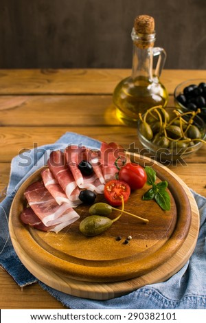 spanish snacks  on a wooden board on a wooden table