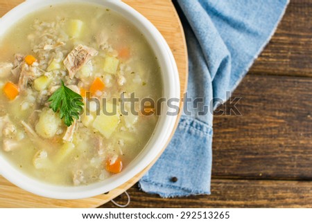 Polish Pearl Barley Soup on a brown wooden table