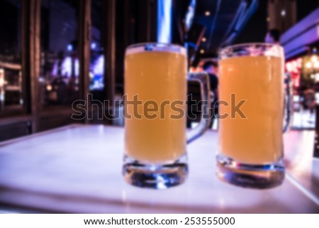out of focus double grasses of beer at  party nightclub in night scene