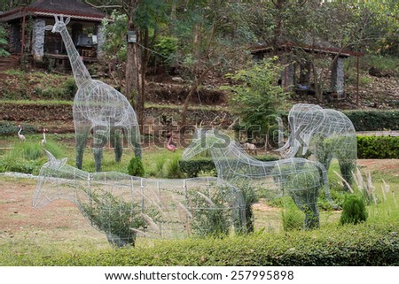 topiary plant pot wire animal shape in garden