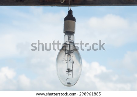 old retro light bulb in not use condition with sky background
