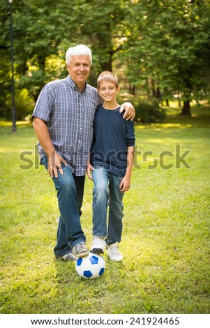 Grandfather and grandson in the park