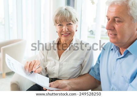 Senior couple read the form for life insurance