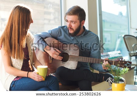Young Couple playing Guitar