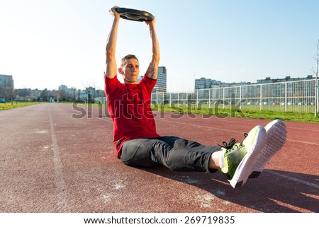 Athletic Man Lifts Weights