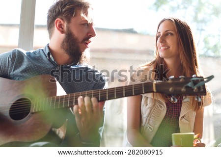 Young Couple playing Guitar