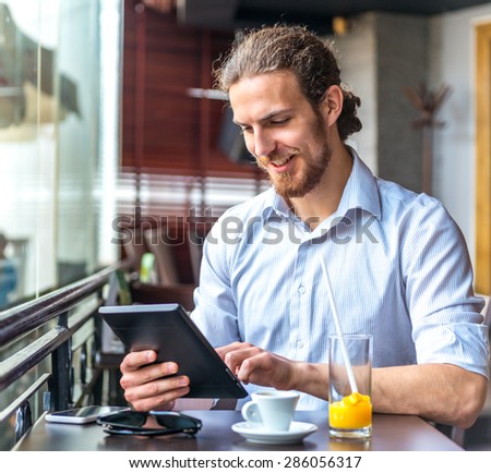 Man with tablet in cafe